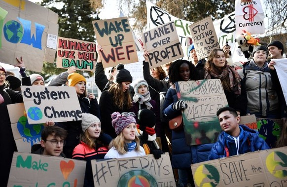 TOPSHOT - Swedish climate activist Greta Thunberg (C) marches during a &quot;Friday for future&quot; youth demonstration in a street of Davos on January 24, 2020 on the sideline of the World Economic  ...