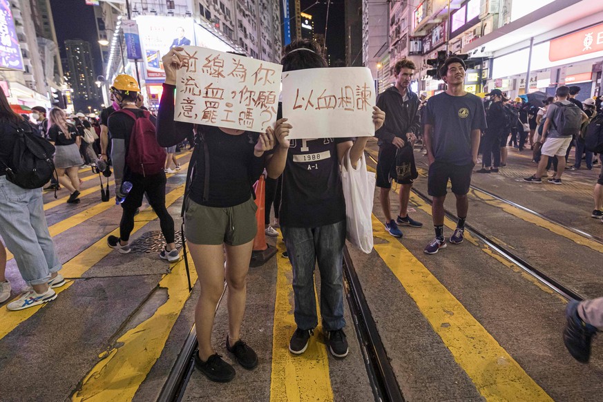 August 4, 2019, Hong Kong, Hong Kong, Hong Kong: Demonstrators hold placards, during protests against the extradition bill..Pro-democracy protesters have continued weekly rallies on the streets of Hon ...