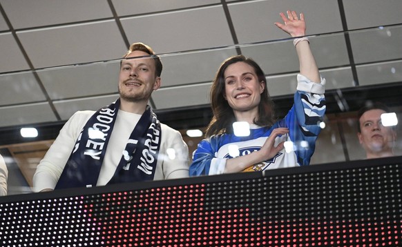 Prime minister of Finland Sanna Marin and husband Markus Räikkönen cheers during the 2022 IIHF Ice Hockey World Championships final match between Finland and Canada in Tampere, on May 29th, 2022. Tamp ...