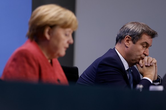 German Chancellor Angela Merkel and Bavarian Federal State Premier Markus Soeder attend a news conference on the coronavirus disease (COVID-19), following video consultations with the premiers of Germ ...