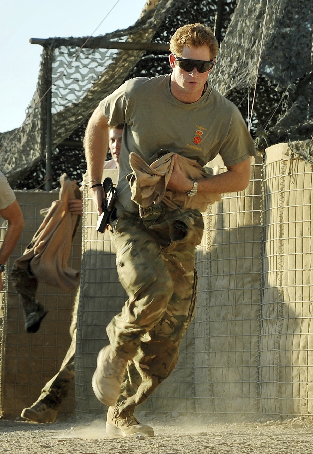 FILE - Britain&#039;s Prince Harry races out from the VHR (very high ready-ness) tent to scramble his Apache with fellow Pilots, during his 12 hour shift at the British controlled flight-line in Camp  ...