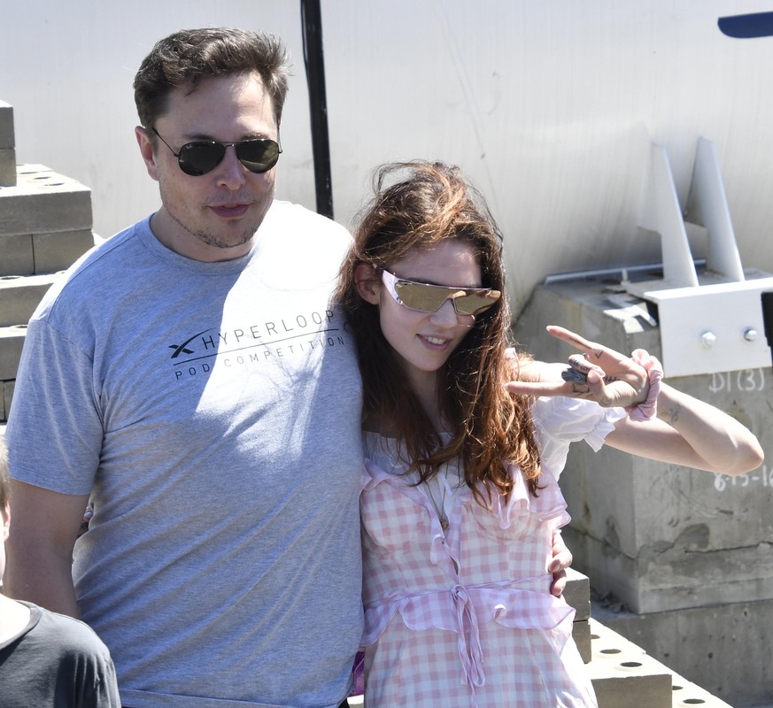 7--22-18. Hawthorne, CA. SpaceX CEO Elon Musk with his new girlfriend singer singer Grimes pose together as the last of 4 teams of students comprised of over 600 competitors from more than 40 countrie ...