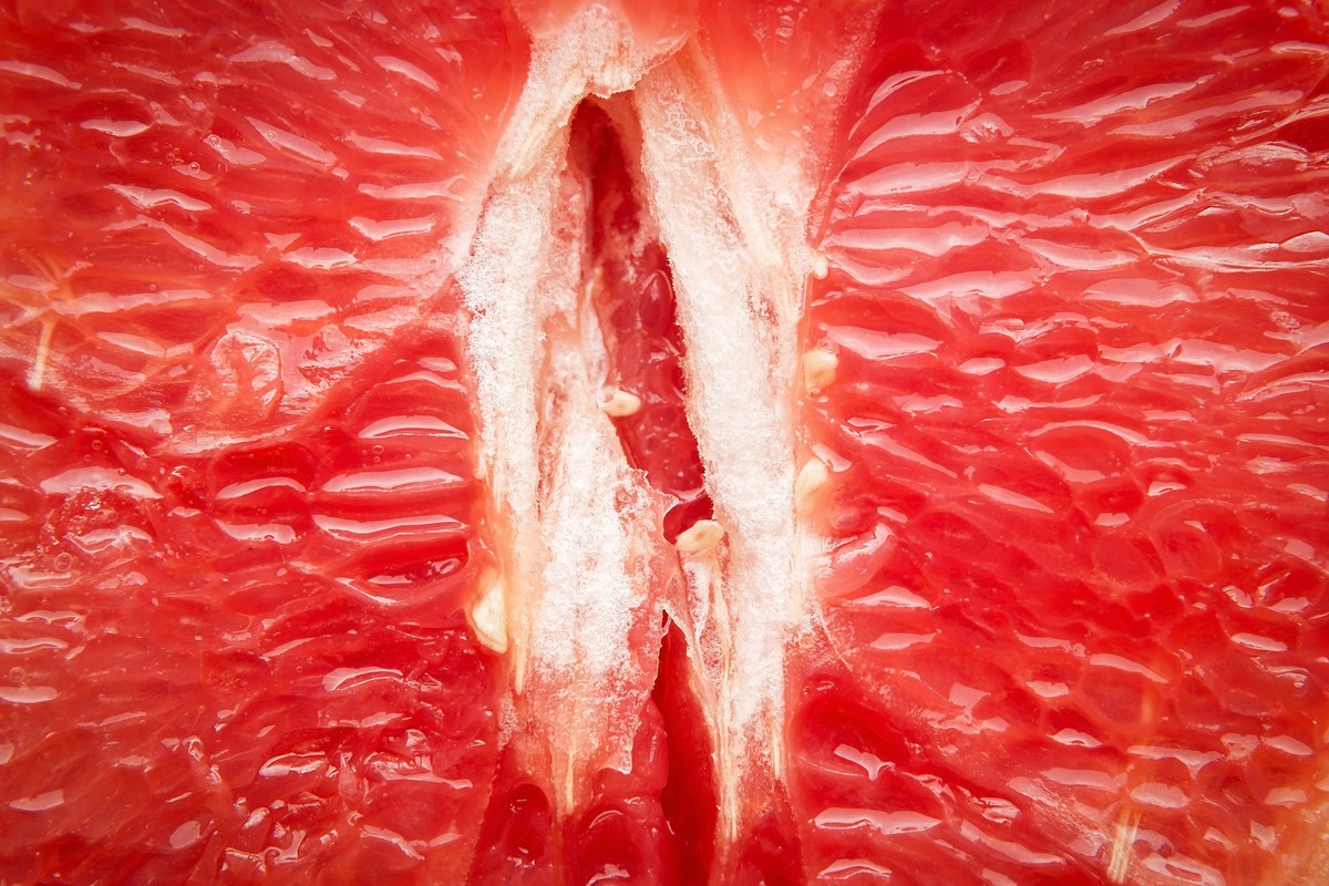 Sexual art minimal concept. Middle of grapefruit with an opening, a macro, close up. Vagina