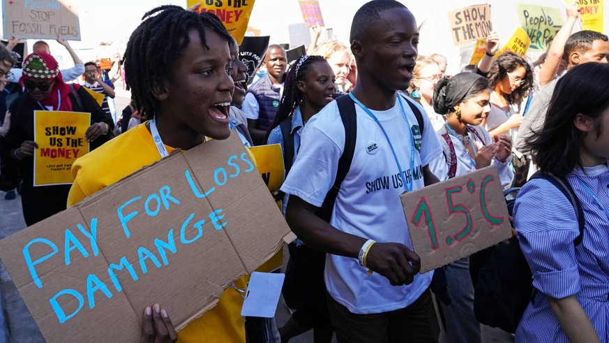 FILE - Vanessa Nakate, of Uganda, left, participates in a Fridays for Future protest at the COP27 U.N. Climate Summit while holding a sign that says &quot;pay for loss and damage&quot;, Friday, Nov. 1 ...