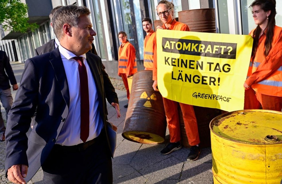 Greenpeace activists stage a demonstration as German Minister of Economics and Climate Protection Robert Habeck arrives to give a press conference on condition of nuclear power plants in front of the ...
