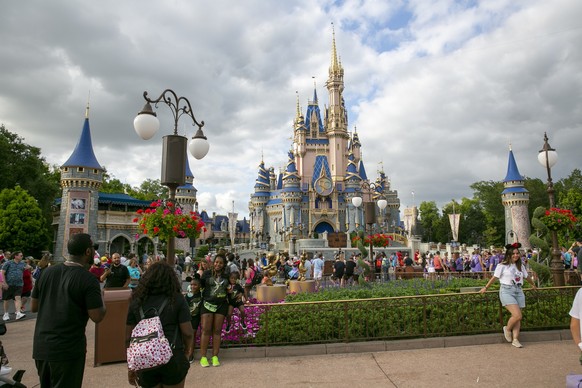 FILE - People visit Magic Kingdom Park at Walt Disney World Resort in Lake Buena Vista, Florida, on Friday, April 22, 2022. Florida lawmakers are meeting to complete a state takeover of Walt Disney Wo ...