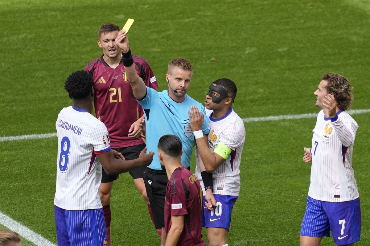 Kylian Mbappe of France pleads with the referee as Aurelien Tchouameni of France is shown the yellow card during a round of sixteen match between France and Belgium at the Euro 2024 soccer tournament  ...