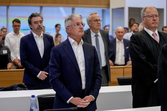 Rupert Stadler, former CEO of German car manufacturer Audi, left, stands in a regional court room and waits for the verdict in Munich, Germany, Tuesday, June 27, 2023. (AP Photo/Matthias Schrader, Poo ...