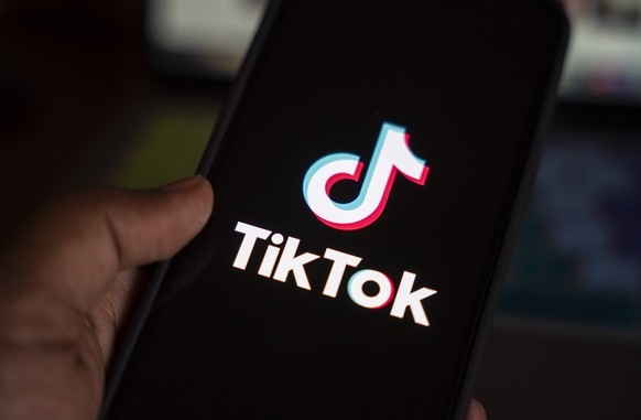 In this photo illustration, logo of Tiktok is displayed on mobile phone screen next to ban sign, in Guwahati, India 25 April 2024. US President Joe Biden signs law to ban Chinese-owned TikTok unless s ...