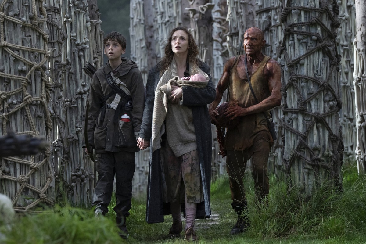 This image released by Sony Pictures shows Alfie Williams, from left, Jodie Comer and Ralph Fiennes in a scene from "28 Years Later." (Miya Mizuno/Sony Pictures via AP)