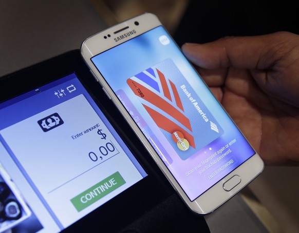 FILE - In this Aug. 6. 2015, file photo, a Samsung employee demonstrates Samsung Pay using a Galaxy S6 Edge Plus in New York. Mobile wallets come in different digital forms. There are device specific  ...