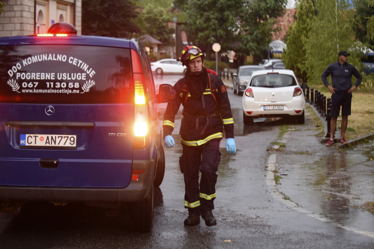 REMOVES SPECIFIC NUMBER OF CASUALTIES AND CLARIFIES SHOOTING DETAILS A firefighter walks by a hearse on the site of the attack in Cetinje, 36 kilometers (22 miles) west of Podgorica, Montenegro, Frida ...