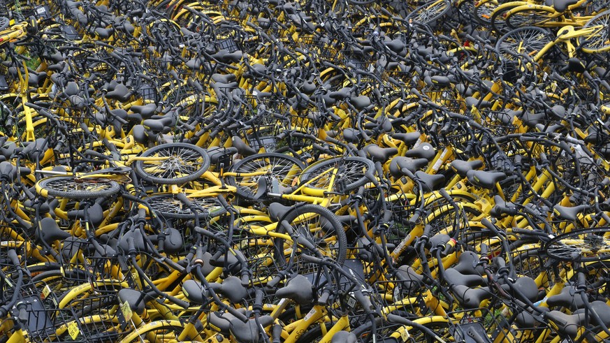 Bicycles of bike-sharing company Ofo are seen on a vacant lot in Zhengzhou, Henan province, China May 20, 2018. Picture taken May 20, 2018. REUTERS/Stringer ATTENTION EDITORS - THIS IMAGE WAS PROVIDED ...