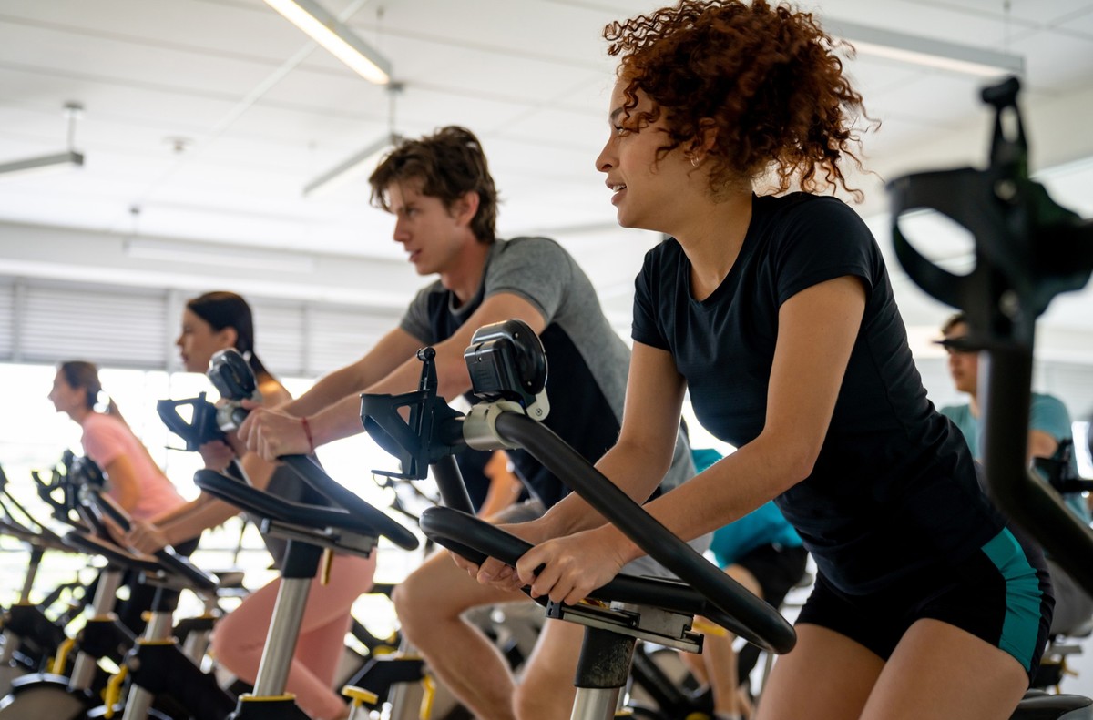 Group of fit people working out in a exercising class - fitness concepts