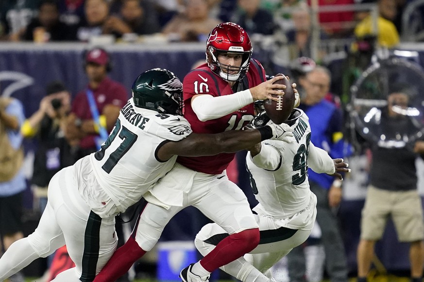 Houston Texans quarterback Davis Mills (10) is sacked by Philadelphia Eagles defensive tackle Javon Hargrave (97) in the first half of an NFL football game in Houston, Thursday, Nov. 3, 2022. (AP Phot ...