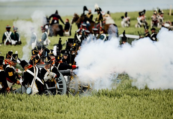 epa04809273 Reenactors perform on the battle field during the first reenactment of &#039;The French Attack&#039; during the bicentennial celebrations for the Battle of Waterloo, in Braine l&#039;Alleu ...