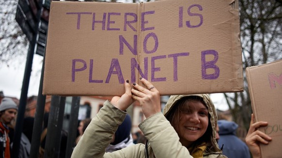 A woman is holding a placard reading &#039;&#039;There is no Planet B&#039;&#039; as Youth For Climate and other collectives and NGOs take to the streets of Toulouse, France, on March 11th, 2023, to d ...