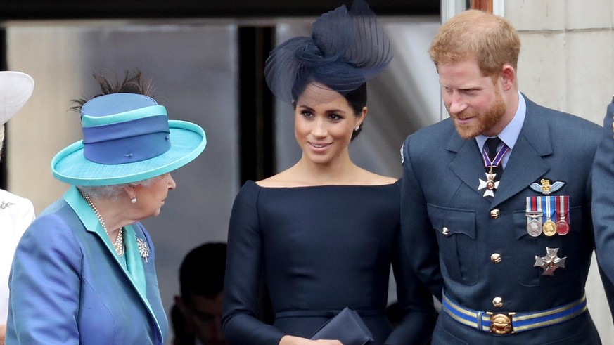 LONDON, ENGLAND - JULY 10: (L-R) Queen Elizabeth II, Meghan, Duchess of Sussex and Prince Harry, Duke of Sussex watch the RAF flypast on the balcony of Buckingham Palace, as members of the Royal Famil ...