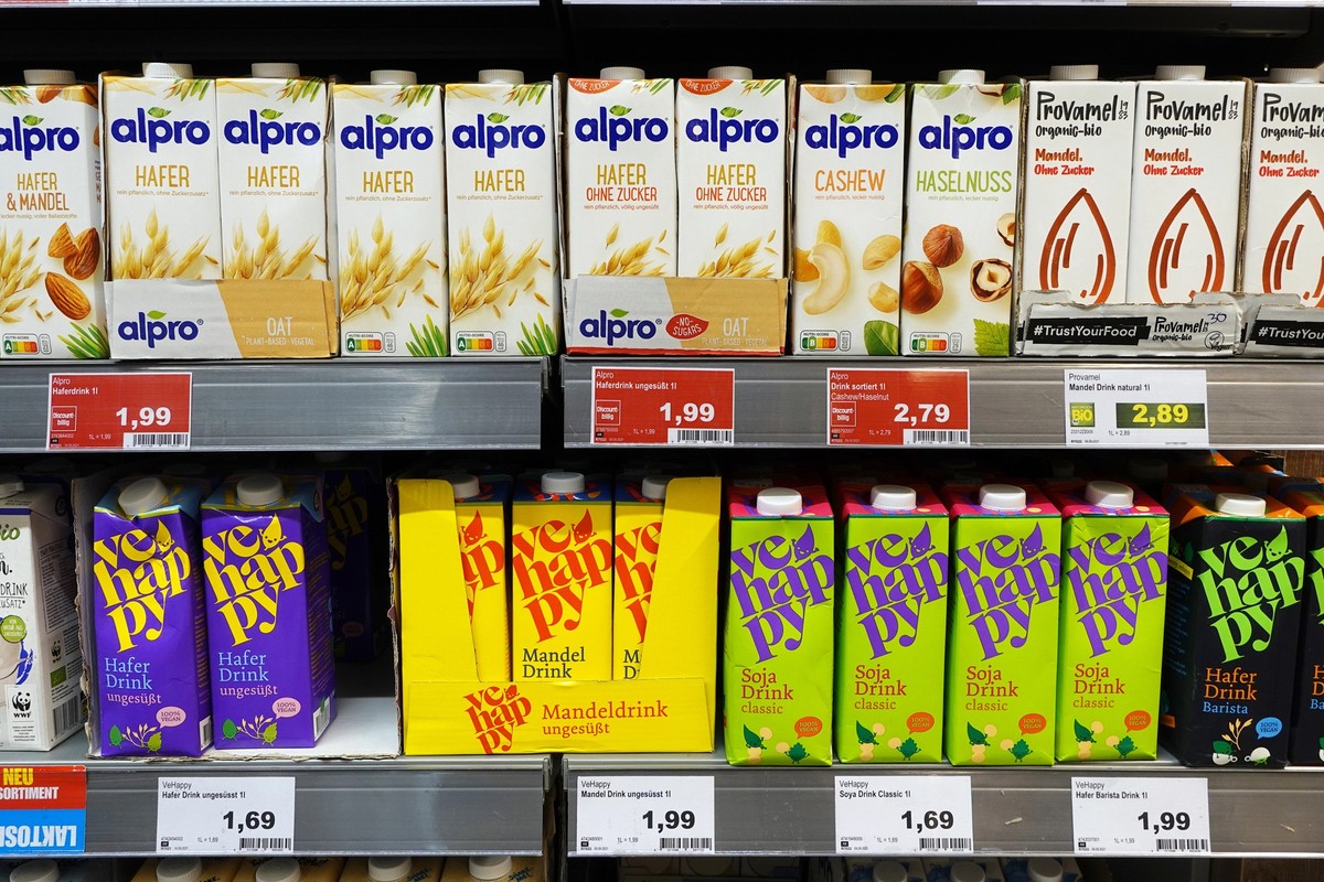 GERMANY - SEPTEMBER 2021:Alpro and VeHappy brand Dairy free Milk product packings in a Marktkauf hypermarket.