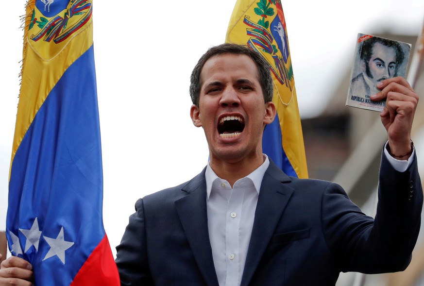 FILE PHOTO: Juan Guaido, President of Venezuela&#039;s National Assembly, holds a copy of Venezuelan constitution during a rally against Venezuelan President Nicolas Maduro&#039;s government and to co ...