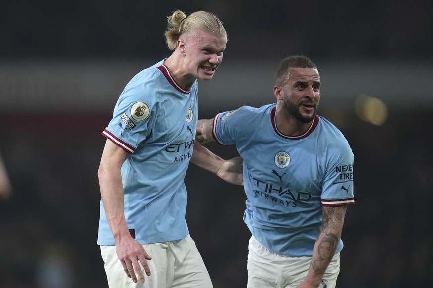 Manchester City&#039;s Erling Haaland and Manchester City&#039;s Kyle Walker celebrate their victory at the English Premier League soccer match between Arsenal and Manchester City at the Emirates stad ...