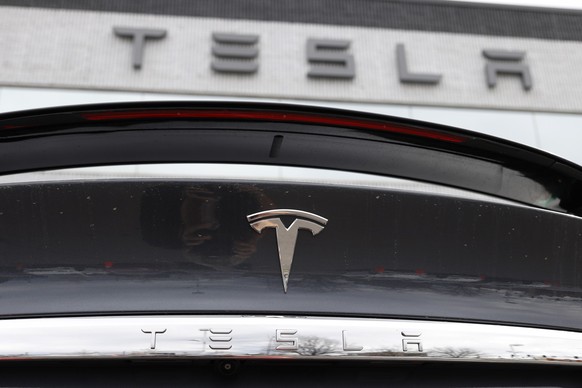 FILE - The company logo shines off the rear deck of an unsold 2020 Model X at a Tesla dealership in Littleton, Colo, on April 26, 2020. A conglomerate of unions in Norway on Wednesday Dec. 6, 2023 sai ...