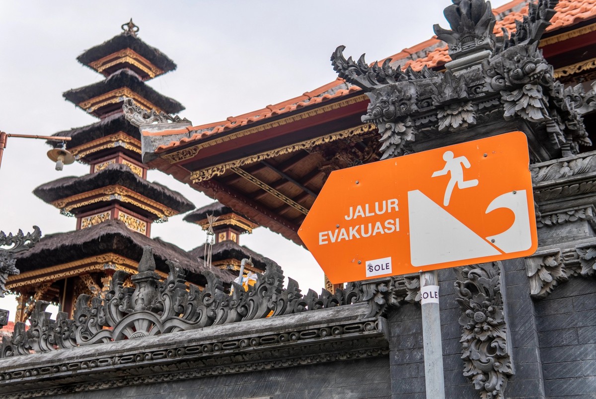 Balinese temple with tsunami warning sign