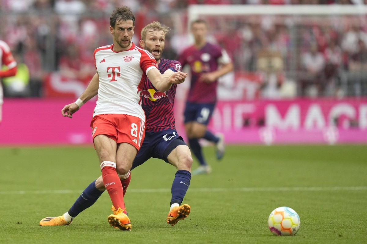 Bayern's Leon Goretzka, left, challenges for the ball with Leipzig's Konrad Laimer during the German Bundesliga soccer match between FC Bayern Munich and RB Leipzig at the Allianz Arena stad ...