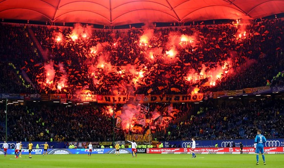 HAMBURG, GERMANY - FEBRUARY 11: Fans of Dresden burn flares during the Second Bundesliga match between Hamburger SV and SG Dynamo Dresden at Volksparkstadion on February 11, 2019 in Hamburg, Germany.  ...