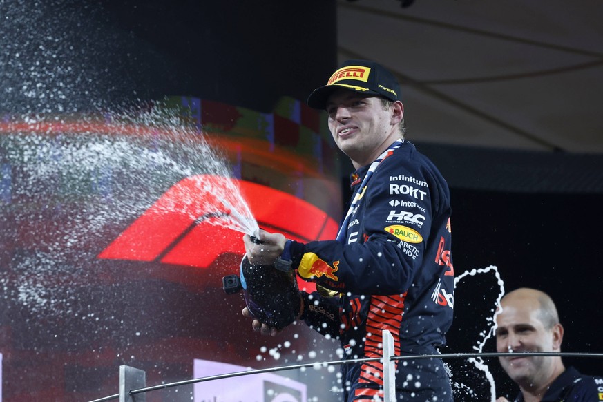 Formula 1 2023: Abu Dhabi GP YAS MARINA CIRCUIT, UNITED ARAB EMIRATES - NOVEMBER 26: Max Verstappen, Red Bull Racing, 1st position, sprays Champagne on the podium during the Abu Dhabi GP at Yas Marina ...