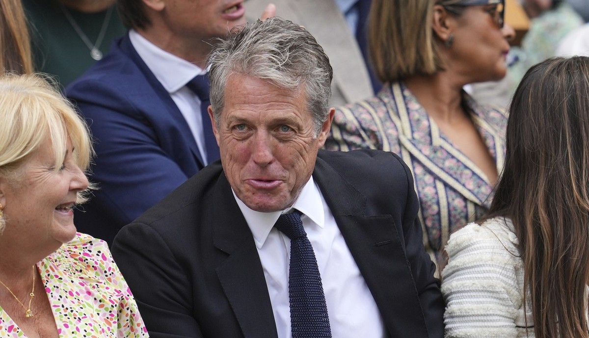 Actor Hugh Grant sits in the Royal Box on Centre Court for day ten at the Wimbledon Tennis Championships in London, Wednesday, July 9, 2025. (AP Photo/Kin Cheung)