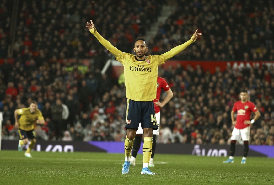 Arsenal's Pierre-Emerick Aubameyang celebrates after scoring the opening goal during the English Premier League soccer match between Manchester United and Arsenal at Old Trafford in Manchester, Englan ...
