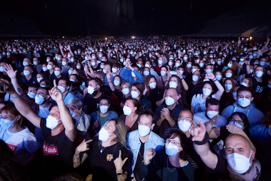 Members of the audience react as the Spanish band Love of Lesbian performs on stage in front of 5,000 people at the Palau Sant Jordi arena in Barcelona, Catalonia, Spain, 27 March 2021. This is the fi ...