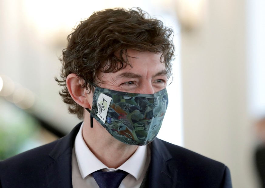The honoured Christian Drosten wears a face mask after the Order of Merit of the Federal Republic of Germany handover ceremony at Bellevue Palace in Berlin, Germany, October 1, 2020. Michael Sohn/Pool ...