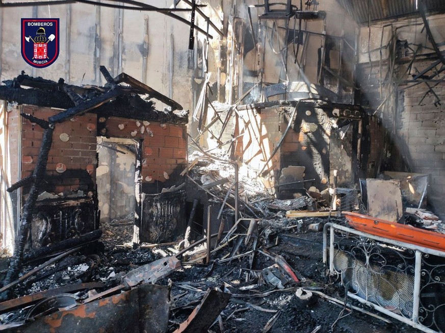 In this photo provided by Bomberos/ayuntamiento de Murcia, part of the burned-out interior a nightclub which caught fire is pictured in Murcia, south-eastern Spain, Sunday Oct. 1, 2023. At least 13 pe ...