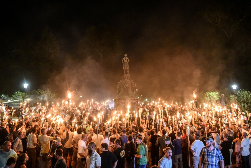 White nationalists participate in a torch-lit march on the grounds of the University of Virginia ahead of the Unite the Right Rally in Charlottesville, Virginia on August 11, 2017. Picture taken Augus ...