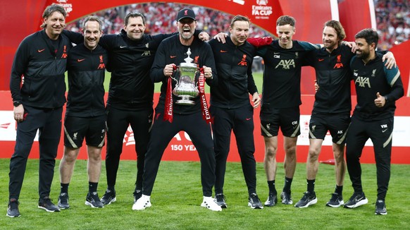Chelsea v Liverpool: The Emirates FA Cup Final Liverpool manager Jurgen Klopp MIDDLE holds the FA Cup with his back Staff after their sides 6-5 penalty shoot-out after a 0-0 draw in normal time FA Cup ...