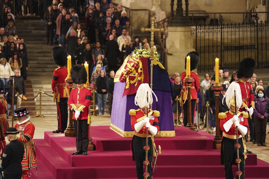 The coffin of Queen Elizabeth II lies in state on the catafalque in Westminster Hall, at the Palace of Westminster, London, early Saturday Sept. 17, 2022. The Queen will lie in state in Westminster Ha ...