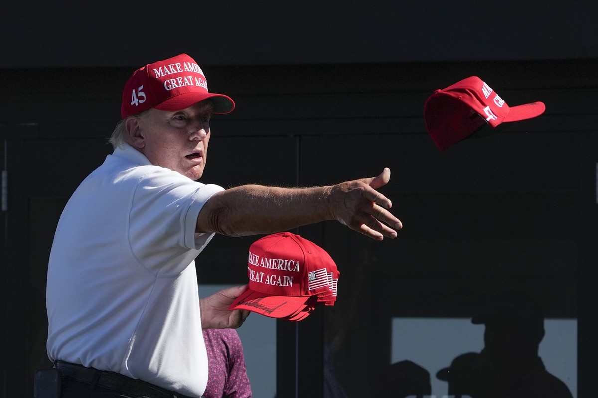 FILE - Former President Donald Trump throws autographed hats to the crowd during the final round of the Bedminster Invitational LIV Golf tournament in Bedminster, N.J., Sunday, Aug. 13, 2023. He&#039; ...