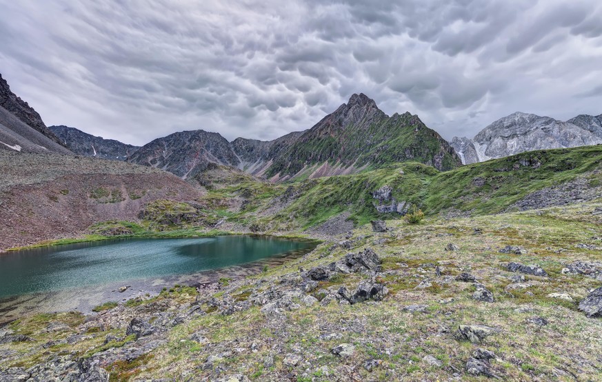 Mammatus cloud over the mountain tundra in Eastern Siberia. Tunka Alps. The Republic of Buryatia