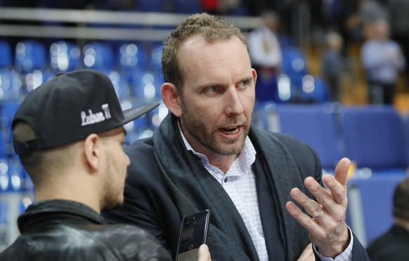 MOSCOW, RUSSIA - MARCH 22, 2017: Brooklyn Nets general manager Sean Marks (R) attends a 2016/17 Euroleague Regular Season Round 27 basketball match between CSKA Moscow and Darussafaka Dogus Istanbul a ...