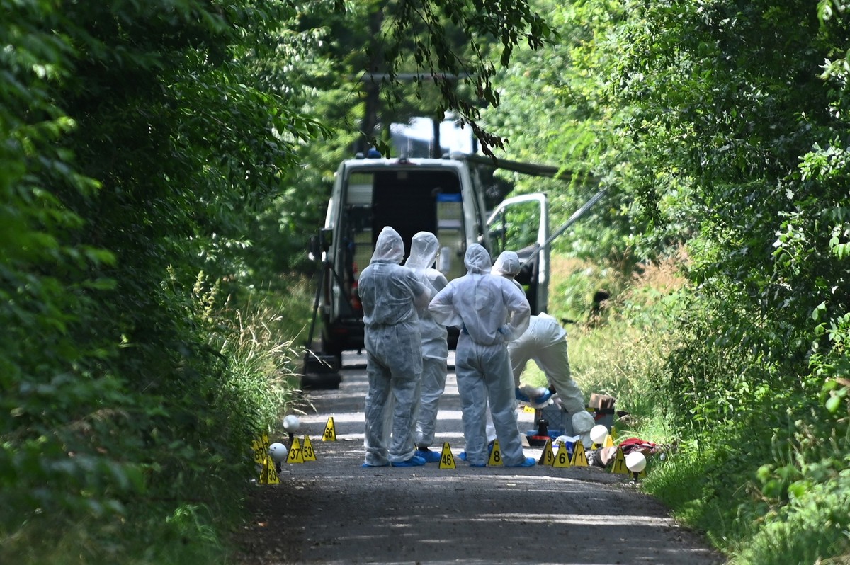 29.06.2025, Nordrhein-Westfalen, Dorsten-Holsterhausen: Ermittler stehen auf einem Weg. Polizisten haben nach einem Hinweis von Passanten an einem Waldweg eine tote Frau und ein totes Kleinkind entdec ...