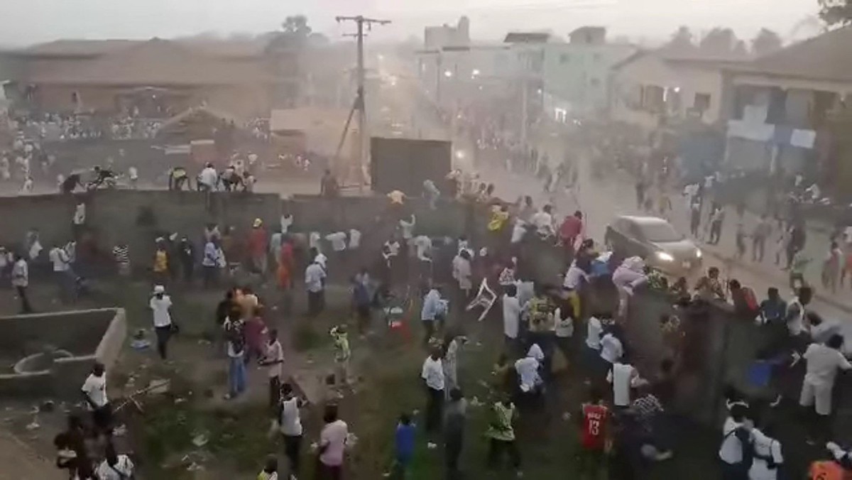 People scramble in Nzerekore, Guinea, where local officials said a deadly stampede ensued at a stadium following fan clashes during a soccer match, December 1, 2024, in this still image obtained from  ...