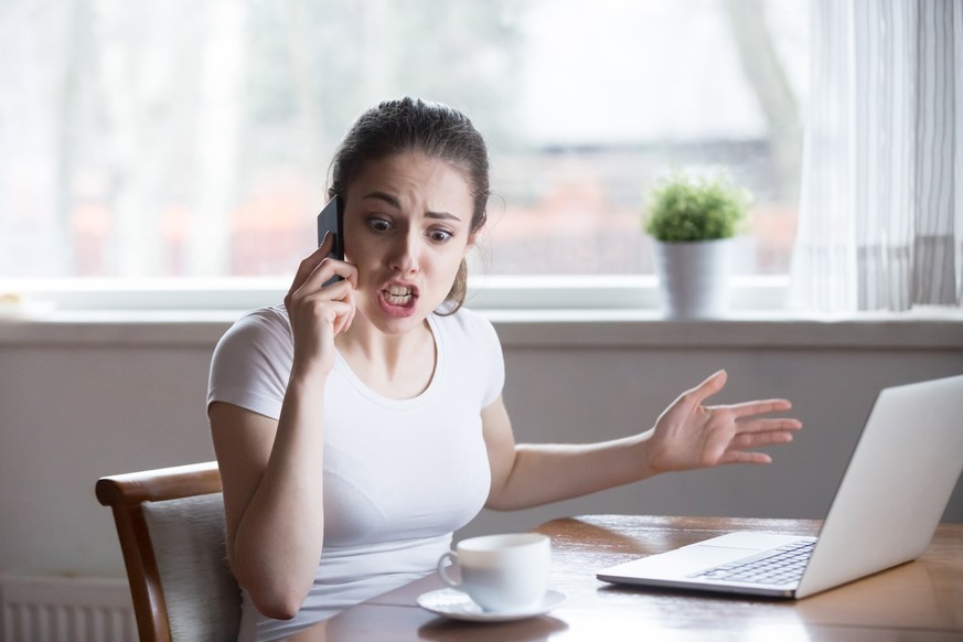 Furious woman argue talking on phone having problems with boyfriend or lover, mad female call customer support have problems with laptop, angry girl scream during emotional conversation over phone