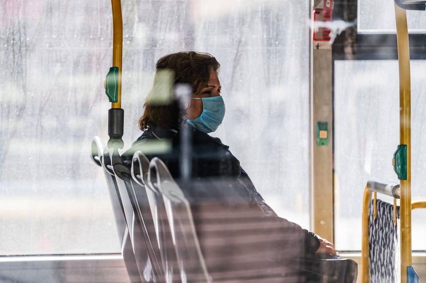 200406 --BERLIN, April 6, 2020 -- A woman wearing a face mask is seen on a bus in Berlin, capital of Germany, April 6, 2020. The confirmed COVID-19 cases in Germany increased by 3,677 within one day t ...