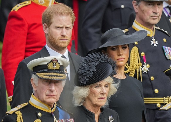 FILE - Britain&#039;s King Charles III, from bottom left, Camilla, the Queen Consort, Meghan, Duchess of Sussex and Prince Harry watch as the coffin of Queen Elizabeth II is placed into the hearse fol ...