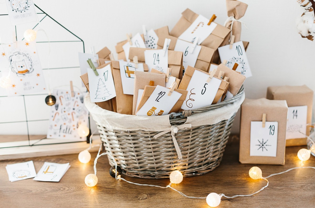 Advent calendar waiting for Christmas. Basket with envelopes with numbers and tasks for children standing on cabinet