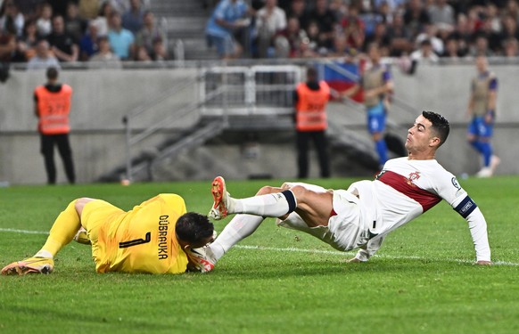 BRATISLAVA, SLOVAKIA - SEPTEMBER 8: Cristiano Ronaldo of Portugal foul on Martin Dubravka of Slovakia during the UEFA EURO, EM, Europameisterschaft,Fussball 2024 European qualifier match between Slova ...