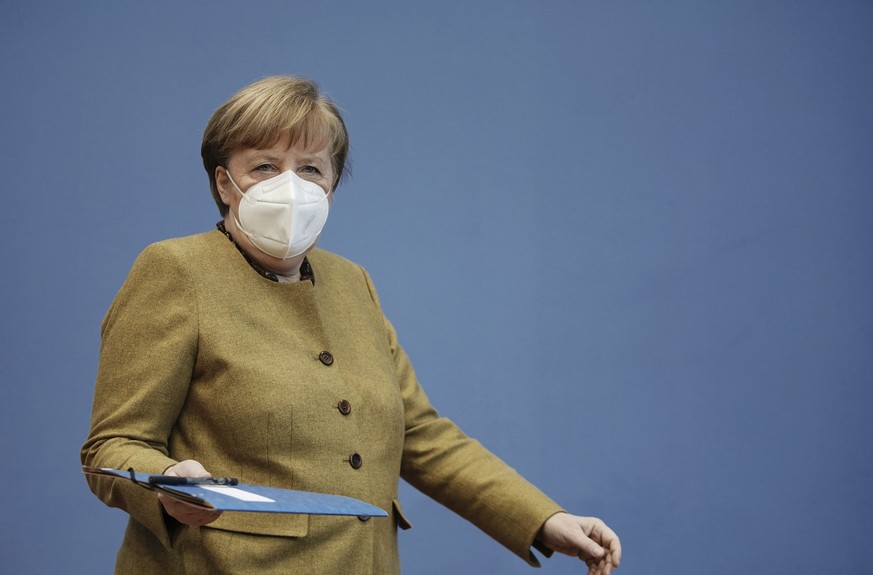 German Chancellor Angela Merkel arrives wearing a protective mask for a press conference on the current situation in Berlin, Germany, Thursday, Jan. 21, 2021. Topics include the decisions taken by the ...