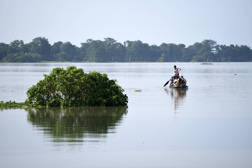 June 28, 2020, Morigaon, Assam, India: Villagers cross a flooded area on boat, at a village in Morigaon district of Assam. More than 200,000 people have been affected by the floods caused by heavy rai ...